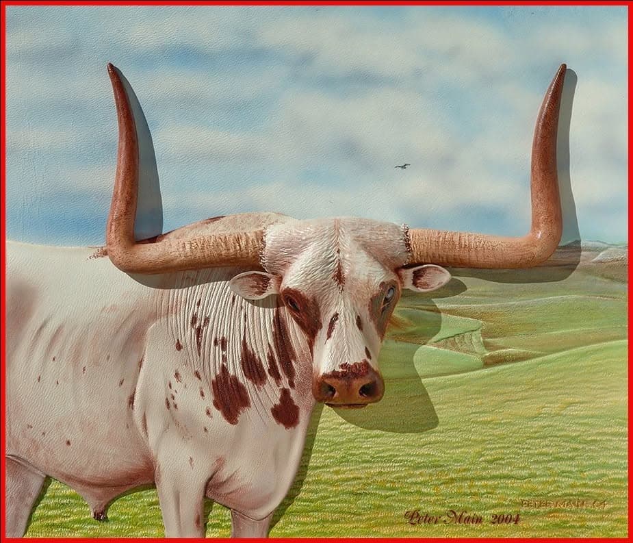 A carved and coloured leather picture of a longhorn steer standing in green rolling country under a wide sky.