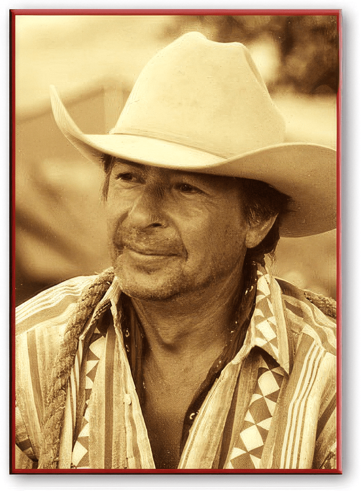 Peter Main, wearing a pale wide-brimmed hat and a patterned shirt, looking off to one side.